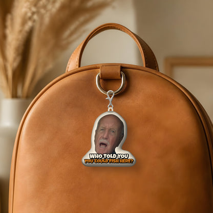 Who Told You You Could Fish Here? sound plush keychain hanging from a leather backpack